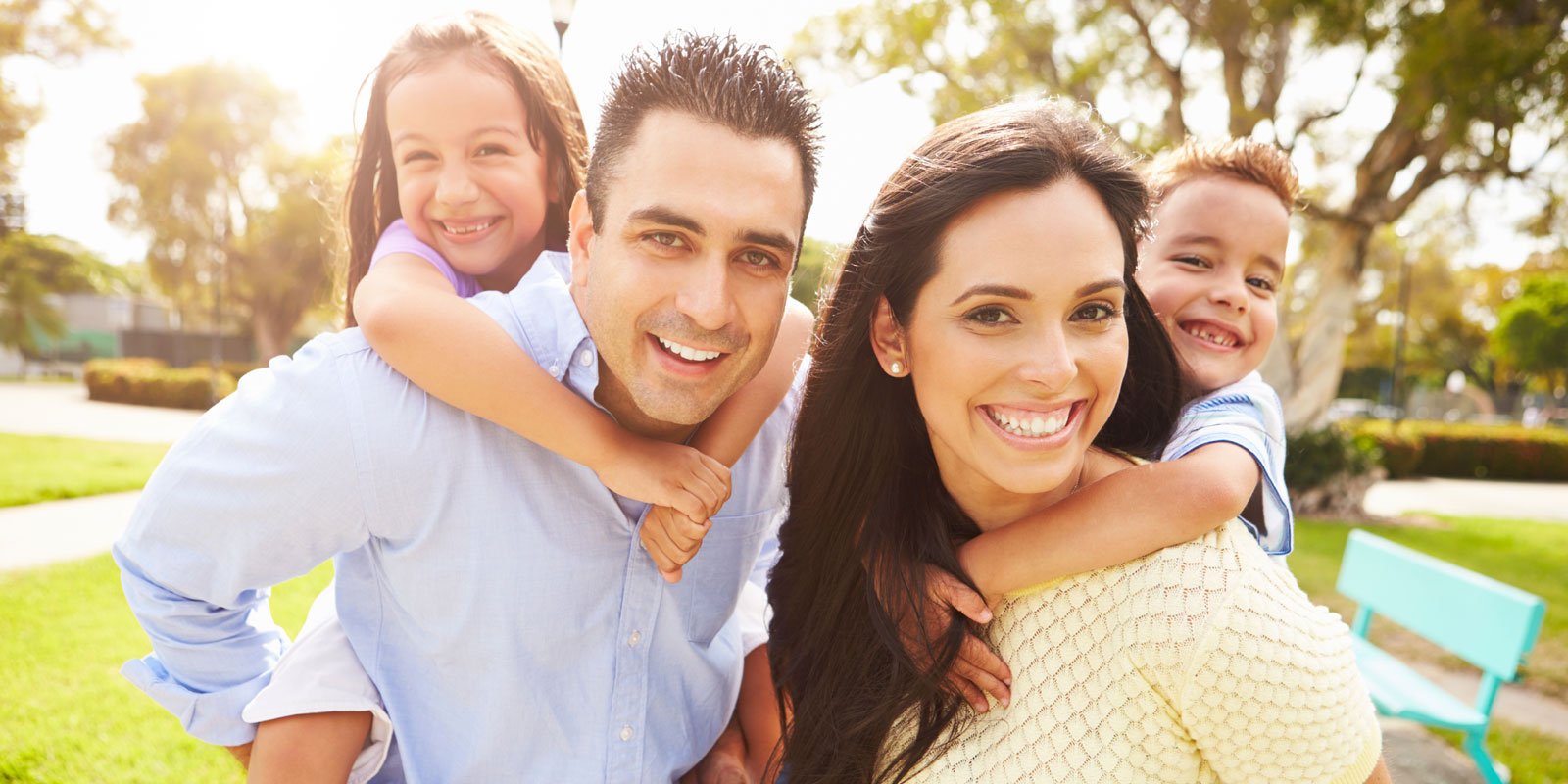mother and father with son and daughter on piggyback